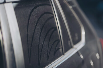 car window Car dust is not cleaned, there are thick dust stains. Ideas for cleaning your car. Concept car wash. Drawing on dirty window car