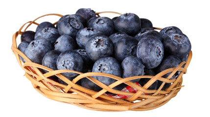 Wicker basket with a red checkered fabric interior overflowing with fresh, ripe blueberries