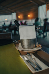 A beautifully arranged table setting in a restaurant featuring a variety of drinks alongside elegant cutlery. The table is adorned with stylish glassware and a vibrant kibla dish.