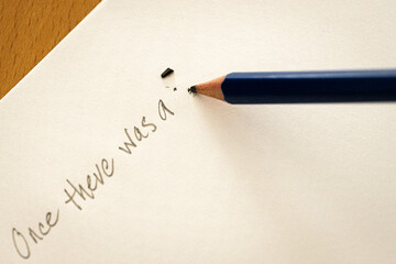 Pencil writing a story. Broken pencil. Desktop writing.