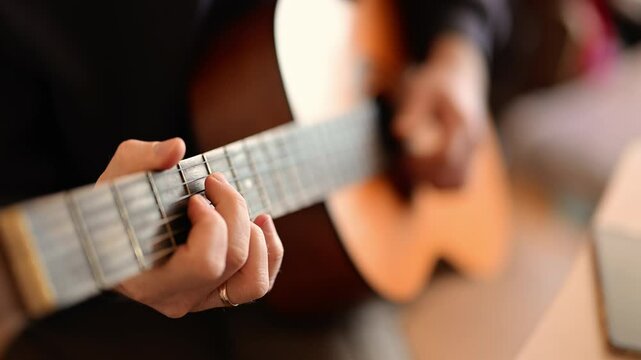 Musician hands strumming guitar, blending technique with emotion.