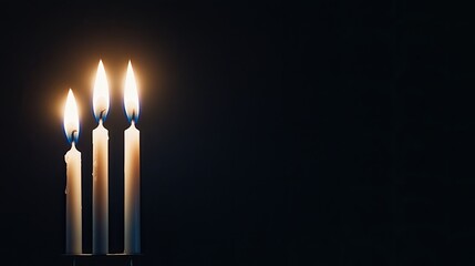 The isolated silhouette of a Hanukkah menorah features lit candles that cast a warm glow, evoking feelings of hope and celebration