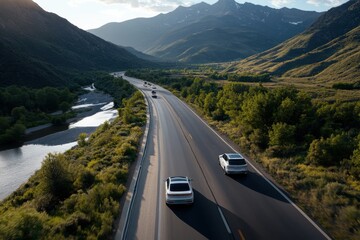 Obraz premium The image captures a road trip along a scenic path, bordered by lush foliage and high mountain peaks, conveying the spirit of exploration and natural wonder.