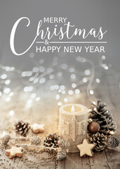 Christmas and Happy New Year Greeting Card - White Christmas candle on rustic wooden boards - Decoration with natural elements, twigs, pine cones and cookies - Advent time