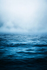 Fototapeta premium calm ocean surface with foggy sky