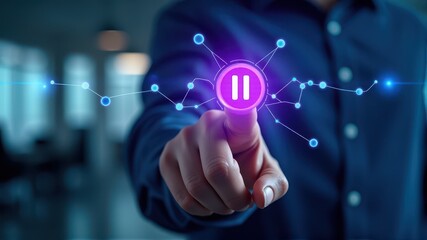 Fototapeta premium A person interacts with a digital interface, pressing a futuristic pause button symbol illuminated with glowing connections.