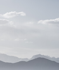 Obraz premium Panoramic minimalist landscape of mountain ranges in Pamir in the Tien Shan Mountains in Tajikistan, silhouette of mountain peaks, landscape for the background