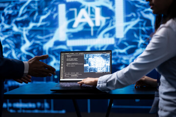 Computer scientist running AI cognitive computing tech on laptop to simulate computerized model....