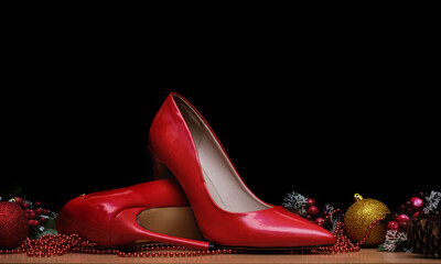 Women's stiletto heels lie on the table next to Christmas decorations