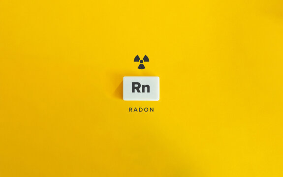 Radon (Rn) Banner image. Radioactive Chemical Element. Radioactivity Symbol and Text on Block Letter Tile on Yellow Background. 