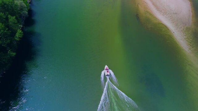 Drone view of the Ticino River and the covered bridge Ponte Coperto, which is used by vehicles and pedestrians. Arched structure. Clear transparent water. Motorboat. Italy. Pavia Italy 17.08.2025
