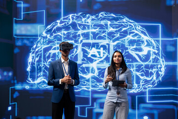Portrait of specialists doing virtual reality demonstration at AI convention gathering tech startups. Engineers at summit event showing how to use VR goggles and artificial intelligence technology