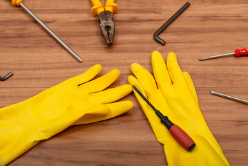 Pair of cleaning gloves, pliers, screwdriver, wrench and other tools
