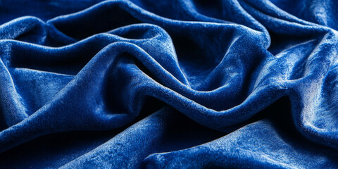 Folded royal blue fabric with a velvety pile, showcasing its rich texture and deep color, making it an ideal backdrop for a sophisticated design