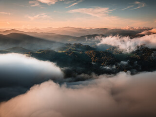 Sunset in the Mountains of Austria with fog filmed with a drone