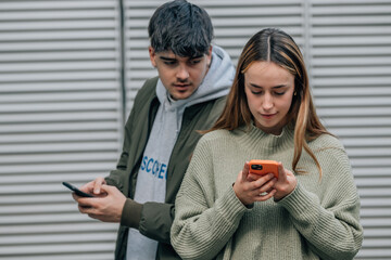 couple spying and looking at mobile phone
