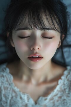 erotic, cunnilingus, sex and masturbation - moaning sexy sensual young Asian woman with open mouth and closed eyes getting sexual pleasure, orgasm, top view