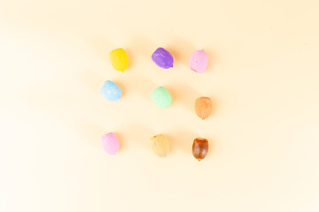 Painted acorns on peach background. Showcasing artistic crafting ideas, perfect for autumn designs,...