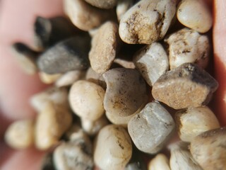 Small stones on the palm close-up