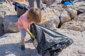 Young child participates in a coastal cleanup event