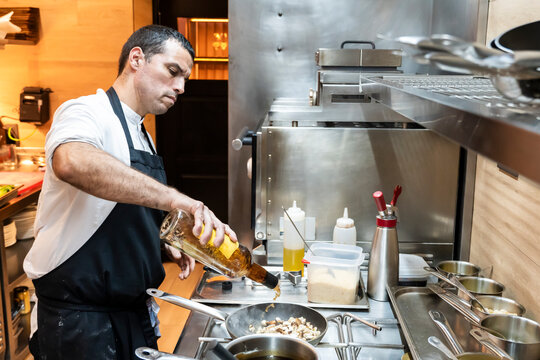 Chef diligently preparing cuisine in a professional kitchen