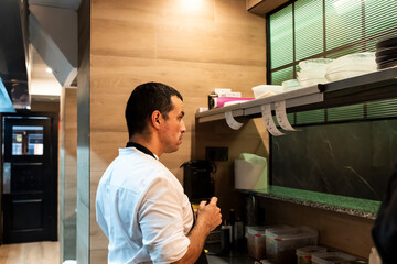 Chef overseeing kitchen operations in a busy restaurant