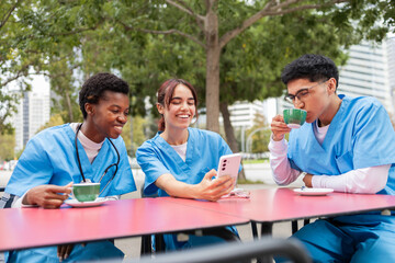 Three nursing students sharing a light moment outdoors