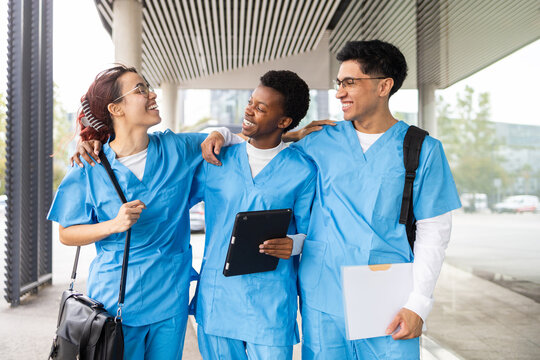 Multicultural nursing students smiling and interacting outside
