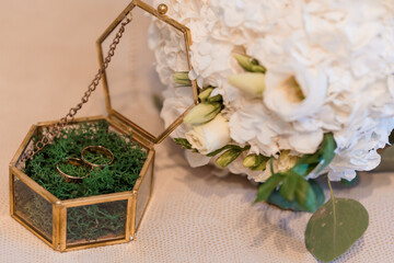 Elegant Wedding Rings Nestled in Floral Bouquet Arrangement