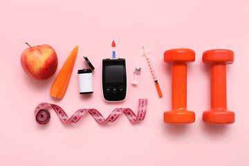 Glucometer with lancet pen, food and dumbbells on pink background. Diabetes concept