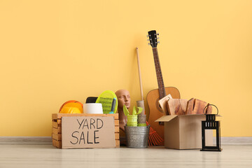 Unwanted stuff for yard sale near yellow wall