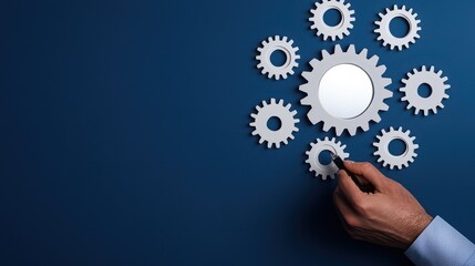 Hand arranging gears on a blue background, symbolizing teamwork and collaboration in business processes.