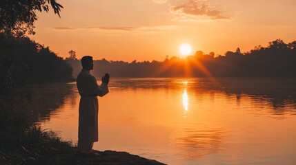 Fototapeta premium An empty scene featuring blank mockup template of a priest standing by the river, offering prayers during the sunrise, 