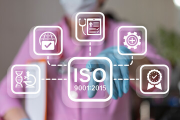 Doctor using virtual touch screen presses inscription: ISO 9001:2015. Health care international...