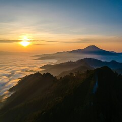 Naklejka premium Serene sunrise over a misty mountain range