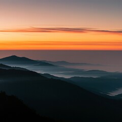Fototapeta premium Serene sunrise over a misty mountain range