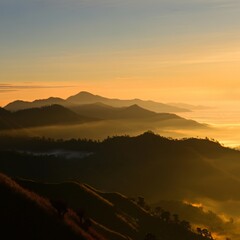 Obraz premium Serene sunrise over a misty mountain range