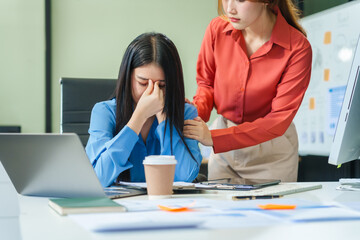 Two young female business consultants work on startup, collaborating on mobile app development social media strategies. whiteboards, documents, they aim to build a successful e-commerce business.