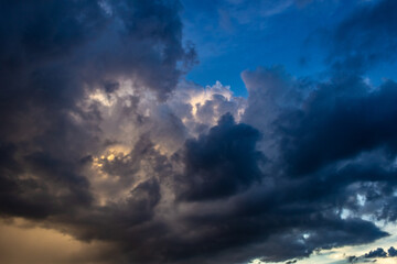 Obraz premium Stormy sky with dark clouds and rainclouds at sunset.