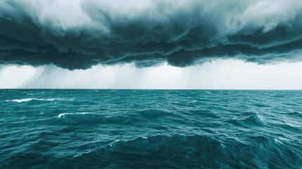 Fototapeta premium Dark storm clouds over a turbulent sea, creating a dramatic and moody atmosphere.