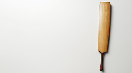 Obraz premium A wooden cricket bat with a brown handle is lying flat on a white surface,copy space