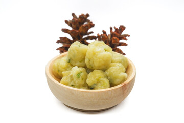 Homemade siomay with soft and chewy texture served in wooden bowl isolated on white background.