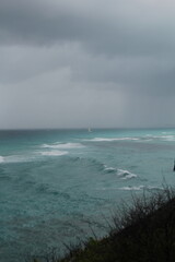 Turquoise waves in the sea with storm in the background in Isla Mujeres, Mexico