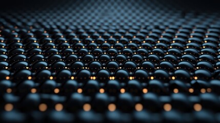 Fototapeta premium Close-up of black spheres with glowing elements on a dark surface, creating a high-tech, abstract scene.