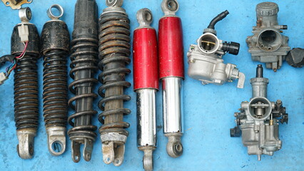 Used motorcycle spare parts at the flea market. Shockbreaker and carburetor