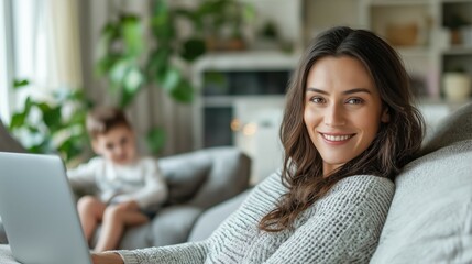 Fototapeta premium Professional photo of a woman sitting on the sofa of her home with in front of a laptop while working from home