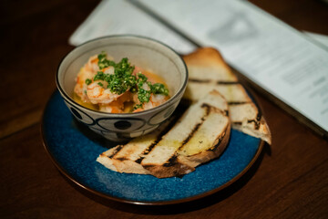 saute prawn appetizer with bread in a Spanish restaurant