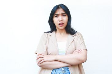 Obraz premium shocked asian woman looking at camera with crossed hand wearing casual clothes isolated on white background
