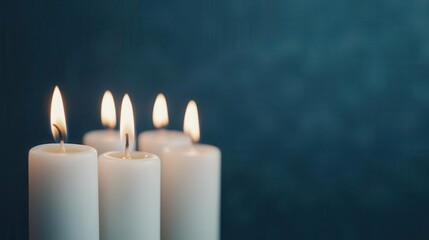 Hanukkah candles glowing softly against a dark background, peaceful and serene holiday moment