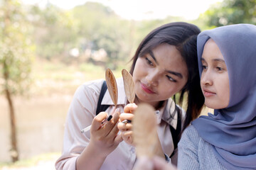 Asian Muslim Girls Studying Plants Outdoor For Education During A Field Trip